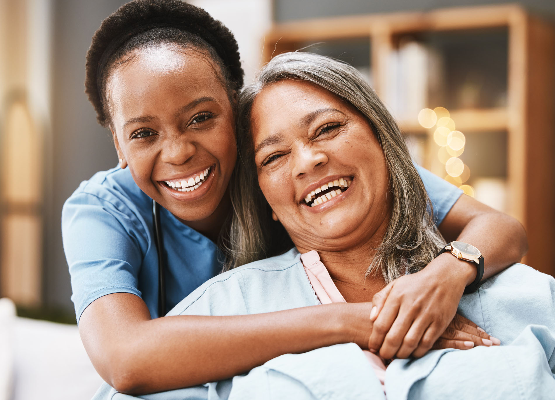 A caregiver providing in home senior care shares a smile with a senior. 